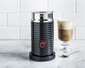 black nespresso milk frother beside a latte