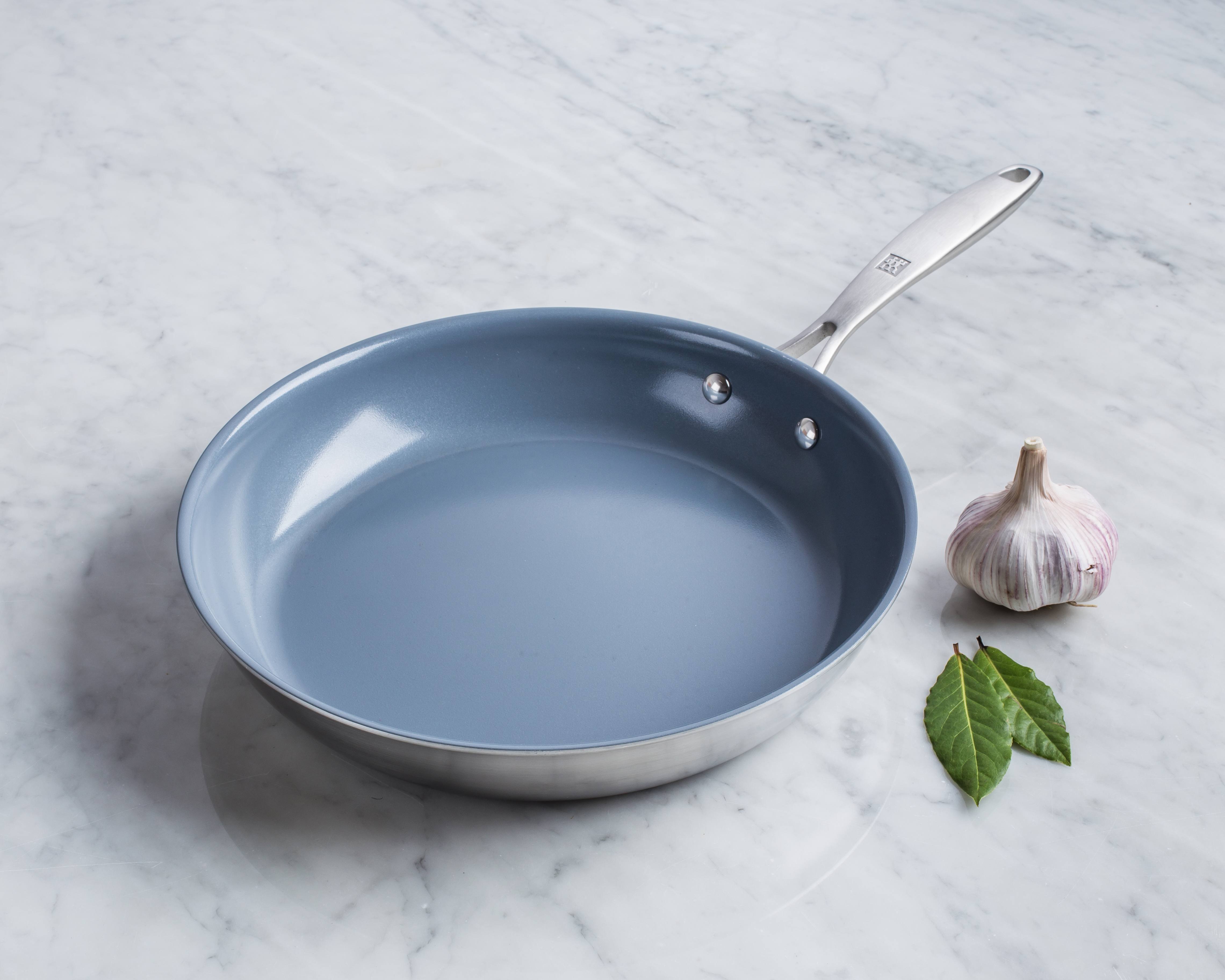 non stick frypan with blue coating, garlic bulb and mint leaves
