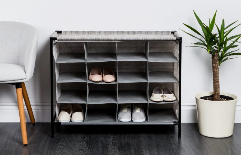 Grey fabric grid shoe cabinet with 12 shoe slots.