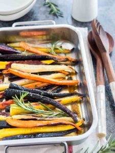 colourful carrots in a pan with rosemary