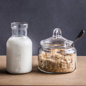 cream in a glass bottle, brown sugar in a glass sugar bowl